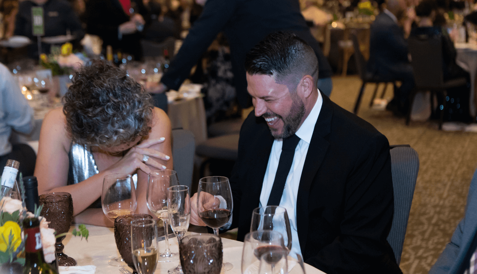 A man and woman laughing at an event